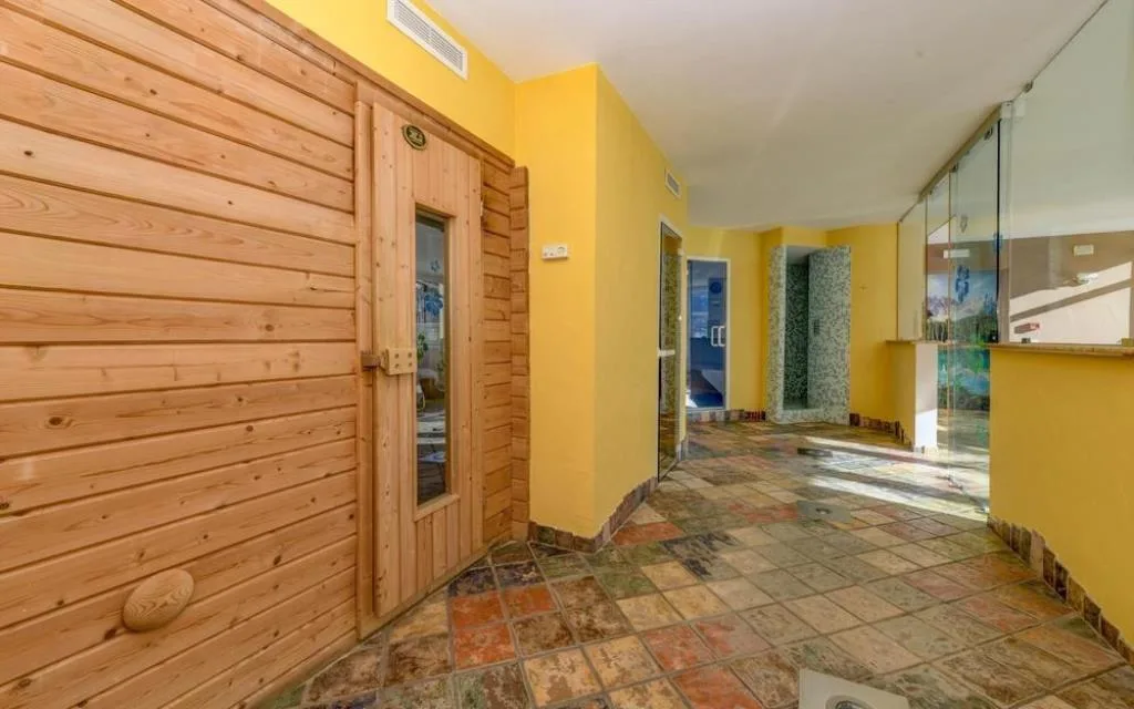 Area benessere con sauna in legno e ingresso al bagno turco