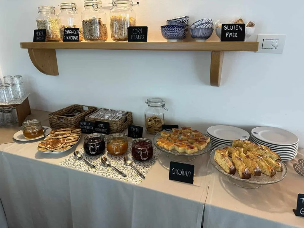 Buffet della colazione con cereali, marmellate, crostata e opzioni gluten free